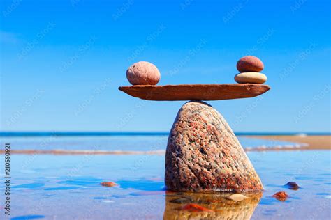 Symbolic scales made of stones on the sea background. Concept of ...
