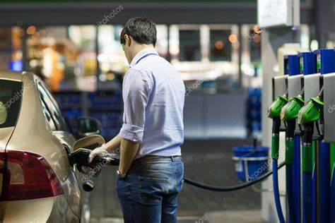 Young man fueling his car at the gas station Stock Photo by ©lightpoet ...