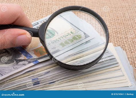 Magnifying Glass Over the Banknote Bundle of US Dollar Stock Image ...