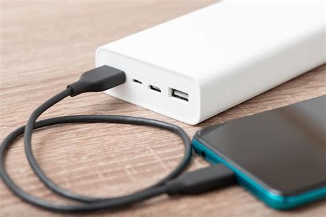 Premium Photo | Power bank charging smartphone focus on power bank ...