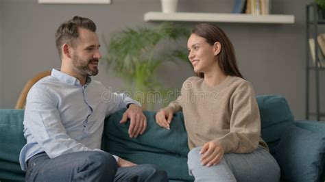 Couple Having Conversation while Sitting on Sofa Stock Photo - Image of indoor, home: 245467944
