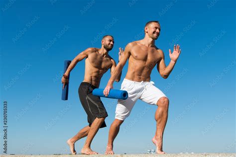 Enhancing the benefit of health activities. Muscular men do sport. Men ...