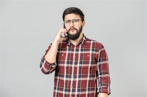 Premium Photo | Portrait of busy adult man talking on phone expressing ...