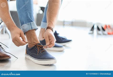 Young man trying on shoes stock photo. Image of person - 113193654