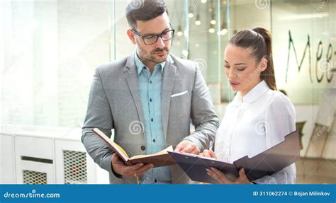 Handsome Business Man Checking Paper Documents with Female Partner at ...