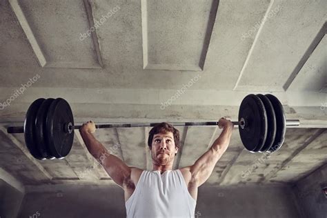 Man lifting heavy weigths — Stock Photo © mavoimages #105573834