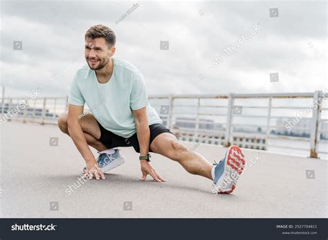 Man Performing Dynamic Stretching Exercise Outdoors Stock Photo 2527704811 | Shutterstock