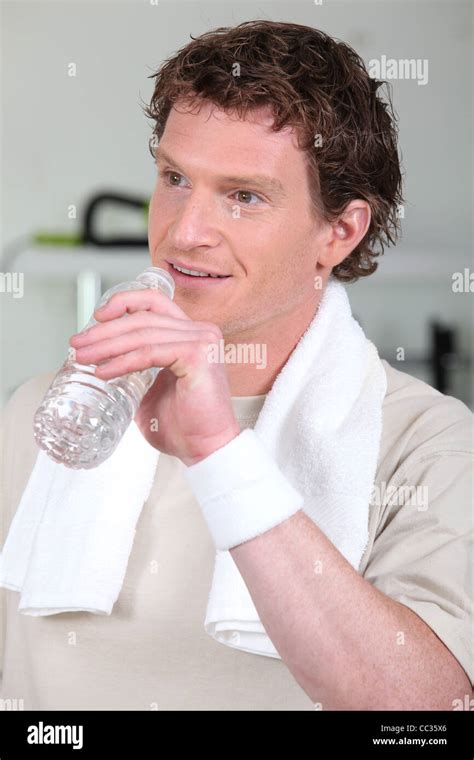 a man drinking water after fitness Stock Photo - Alamy