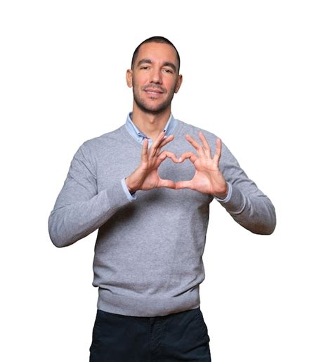 Premium Photo | Happy young man doing a gesture of love with his hands
