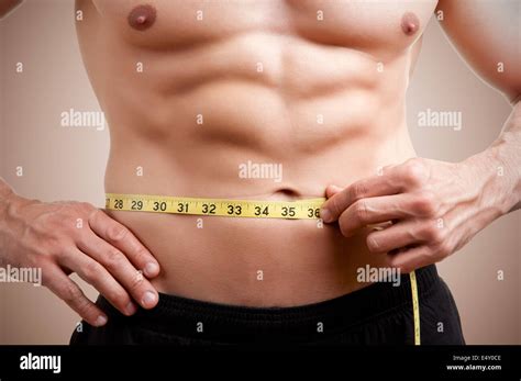 Measuring belly man hi-res stock photography and images - Alamy
