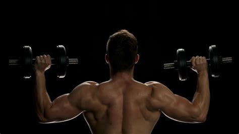 Muscular Man Lifting Dumbbells Young Man Stock Footage SBV-321723522 ...