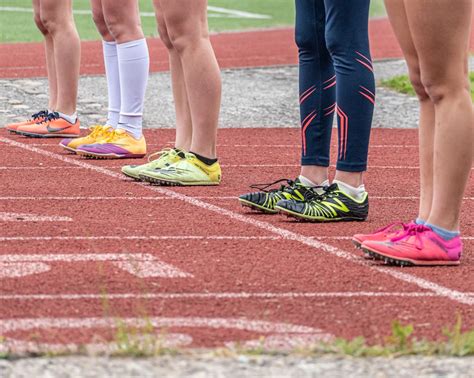 People Wearing Running Shoes Standing on the Track · Free Stock Photo