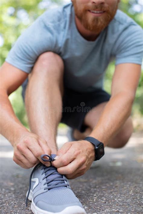 Runner Man Tying Shoe Laces Stock Photo - Image of active, watch: 273525212