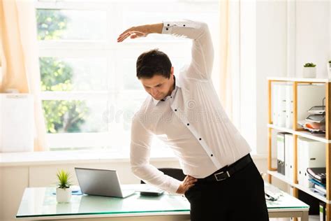 Businessman Doing Stretching Exercise Stock Photo - Image of office ...