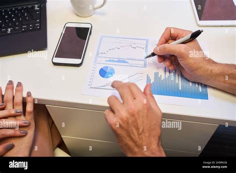 Hands of business man on desk during financial planning with graph and ...