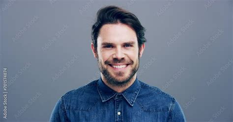 Man, face and laughing on grey studio background at joke, humor and ...