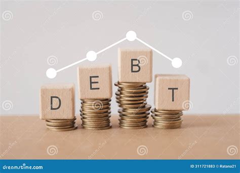DEBT Word on Wooden Cube Blocks Word on Stack of Coin and Graph Above ...