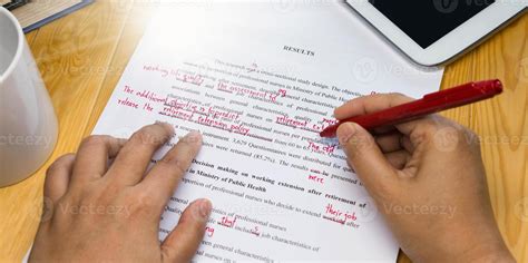 hand holding red pen over proofreading text 11842438 Stock Photo at Vecteezy
