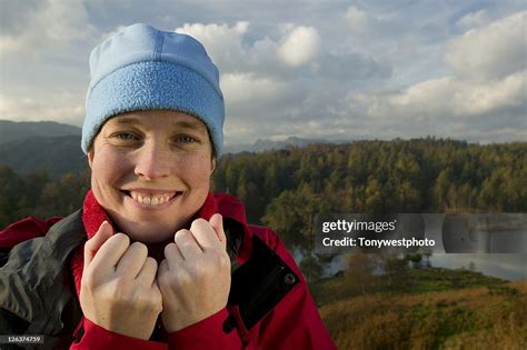 Smiling Face Of Female Hiker With Lake And Mountain Views In Background In The Lake District ...