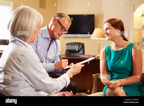 Older Couple Talking To Financial Advisor In Office Stock Photo - Alamy