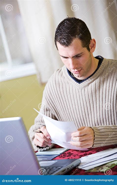 Finances: Man Reads Bills while Doing Finances Stock Photo - Image of ...