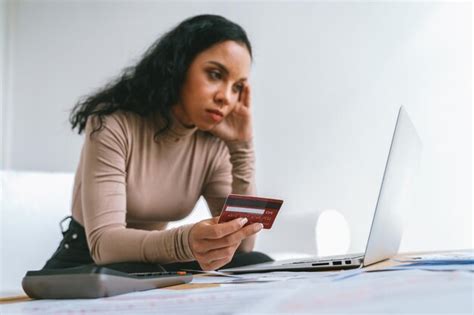 Premium Photo | Stressed young woman has financial problems with credit card debt to pay crucial ...