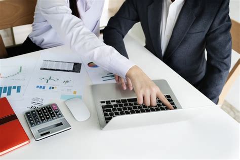 Premium Photo | Business man using calculator to review balance sheet ...