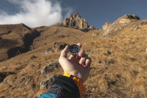 A Male Hiker is Looking for a Direction with a Magnetic Compass in the ...