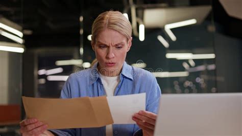 Confused Female Reading Document and Finding Out about Bank Problem at ...