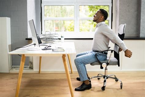 Employee Stretching at Office Desk Stock Photo - Image of american, male: 232136816