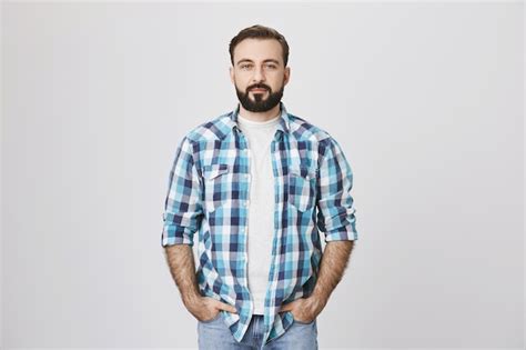 Free Photo | Confident bearded adult man with hands in pockets